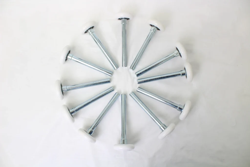 Top view of multiple nylon rollers with metal shafts arranged in a circular pattern.