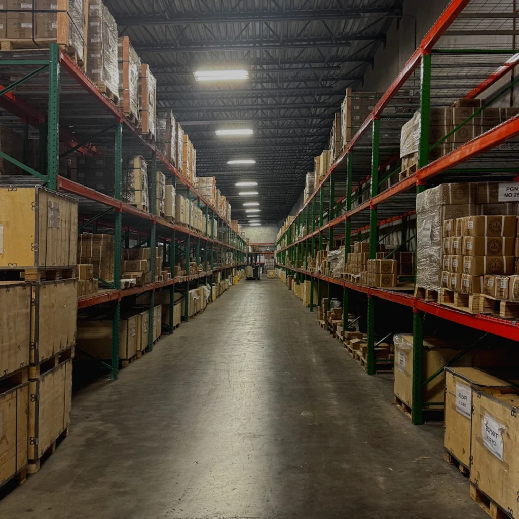 Large industrial warehouse aisle with shelves stocked with PGN inventory.
